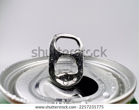 Close up Lid opens soft drink cans and drops of water. Royalty-Free Stock Photo #2257231775