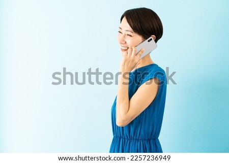 Young woman in a dress talking on a smartphone