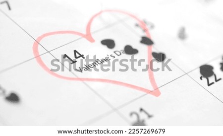 Valentine's day concept close up of calendar sheet with 14th february date marked by red heart shape