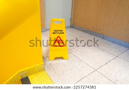 "Caution wet floor" sign in stairs