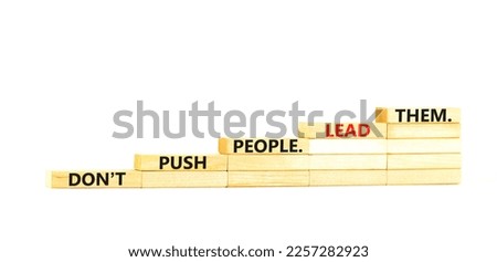Push or lead people symbol. Concept words Do not push people lead them on wooden blocks. Beautiful white table white background. Business Push or lead people concept. Copy space.