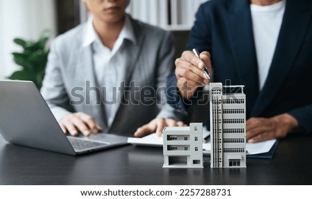 Discussion with a real estate agent. Real estate agent having a discussion with his client about purchasing house. Royalty-Free Stock Photo #2257288731