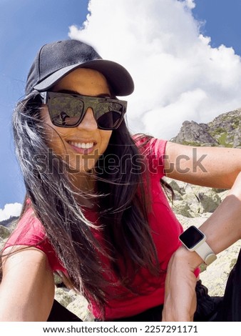 Woman  with hat and sunglasses in the summer mountain 