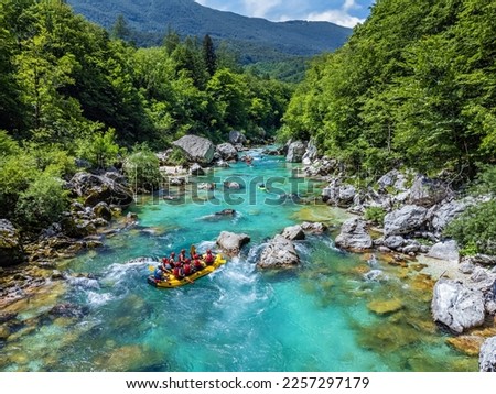 Soca Valley, Slovenia - Aerial view of the emerald alpine river Soca with rafting boats going down the river on a bright sunny summer day with green foliage. Whitewater rafting in Slovenia Royalty-Free Stock Photo #2257297179