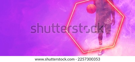 Low section of african american basketball player with ball walking by hexagon on purple background. Copy space, composite, illuminated, sport, competition, illustration, shape and smoke concept.
