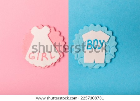 Boy or girl.A set of delicious baby shower cookies on a colorful background. Gender cookies.Baby shower party. Close-up. Flat lay. Place for text.