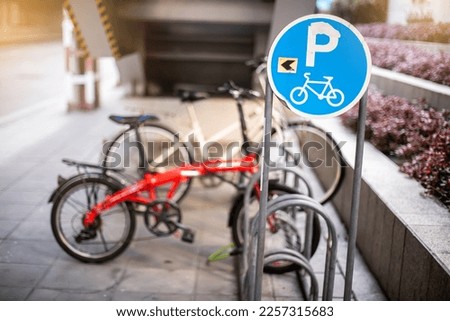 Bicycle parking sign with blurry bicycle.