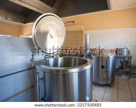 industrial kitchen with huge pots used usually on government, hospital, schools, army establishments to cook large quantities of food . Royalty-Free Stock Photo #2257330483