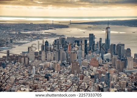 Streets and buildings of Downtown Manhattan and Verrazzano Bridge, aerial view from helicopter. Royalty-Free Stock Photo #2257333705