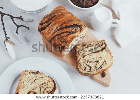 Traditional Romanian sweet bread cozonac decorated bloom. Slices of fresh bread on a plate. Spring and Easter baking. Healthy and organic food. top view. space for text. High quality photo Royalty-Free Stock Photo #2257338821