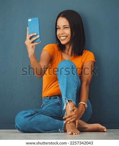 Black woman, floor and home with smile for selfie fashion clothes or relax with beauty by wall background. Gen z girl, smartphone and happy in house with feet, jeans or face photo for profile picture