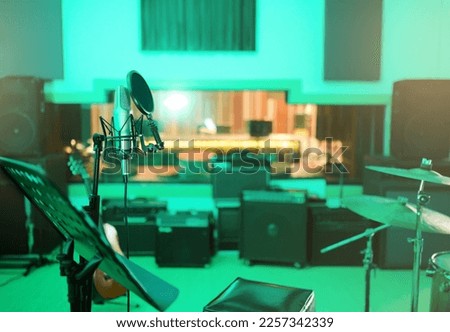 Music, recording studio and interior with instruments for creative, musician or industry background. Audio technology, microphone and sound production for radio, media and electronics in neon lights