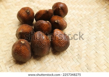 Salak or snake fruit. Group of Salak on woven background