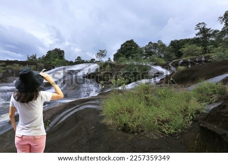 Asia woman to see view on Chanan waterfall at Bueng Kan Province,Thailand