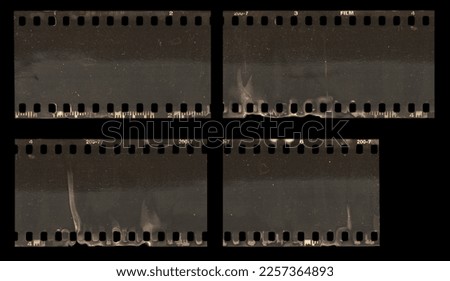 pieces of long 35mm negative film strip isolated, real scan of empty film material with scanning light interferences, dust and developing smear marks, retro photo placeholder or overlay.
