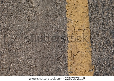 Yellow line background with cracks on the old road