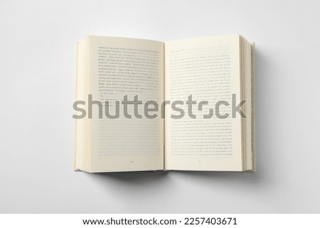 Open book on white background, top view Royalty-Free Stock Photo #2257403671