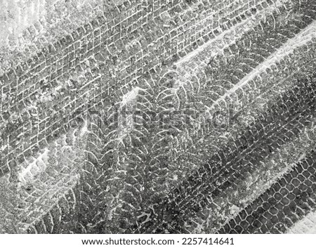 Black and white grunge vector background with texture of tire tracks on snow. UHD 4K wallpaper. For screen, desktop, site design, overlay, stencil, background, stylization, design and polygraph design