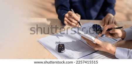 Car Insurance document or lease concept the car broker assisting his customer and explaining the detail of the car contact. Car key Buying or selling signing .	 Royalty-Free Stock Photo #2257415515