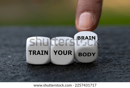 Dice form the expression 'train your body' and 'train your brain'. Royalty-Free Stock Photo #2257431717