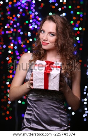 Portrait of beautiful young girl on bright lights background