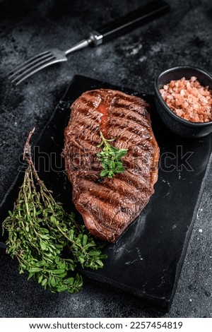BBQ roasted Shoulder Top Blade or Australia wagyu oyster blade beef steak. Black background. Top View. Royalty-Free Stock Photo #2257454819