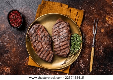 Grilled Shoulder Top Blade or Australia wagyu oyster blade beef steak. Dark background. Top View. Royalty-Free Stock Photo #2257455415
