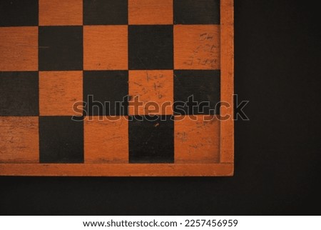 part of a wooden chess board, on a black background