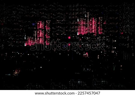 Abstract blurred bokeh of city, neon night lights, illumination, various bright colors in night with reflection. City life in evening, urban defocused background