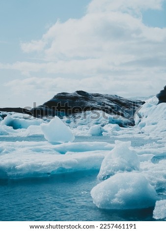 Spectacular drift of giant ice floes from a glacier in Iceland amidst a stunning weather vista