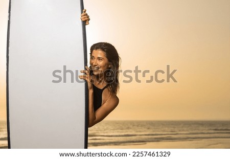 Girl surfer, vacation in Bali, Indonesia. Download a photo with copy space to advertise tours to a warm country. Surfing and vacation picture for social media promo.