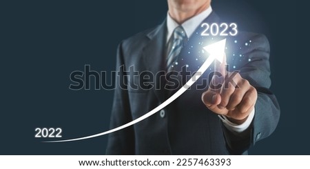 Businessman holding 2023 number, new year concept.