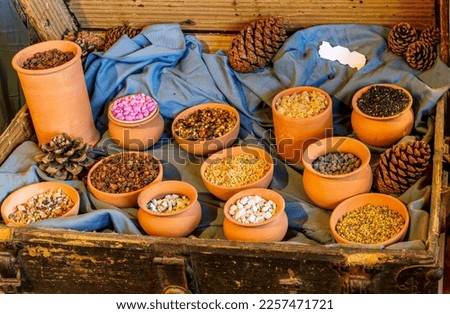 old eastern market shop of spices and dried fruits , cereals and food goods in vintage style with yellow dishes and pots of various goods and spices, bazaar of east concetp Royalty-Free Stock Photo #2257471721