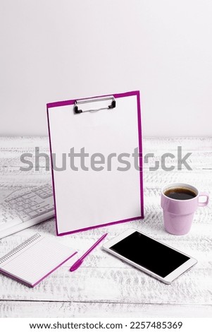 Notebook With Important Messages On Desk With Coffee, Phone And Pen. Crutial Informations Written On Pad On Table With Cup, Memos And Pencil. Late Updates Presented.