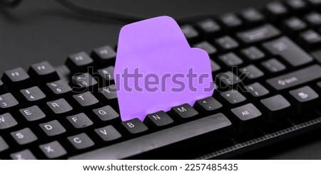 Colored sticker lying on black keyboard. Important information written over paper. Image with school supplies. Multiple Assorted Collection Office Stationery.