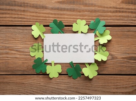 Saint patrick's day clover leaves and empty banner for your text on wooden background. flat lay