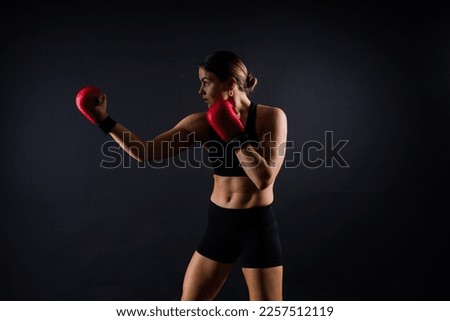 Young woman athletic female MMA fighter training. Concept of sport, action, healthy lifestyle. Royalty-Free Stock Photo #2257512119