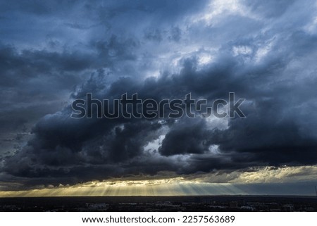 Sunbeams cut through dark, ominous storm clouds hovering over midtown Atlanta. Royalty-Free Stock Photo #2257563689