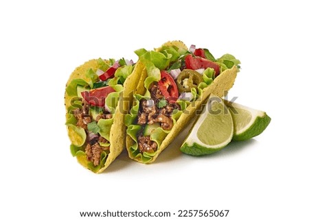 Two tacos with ground beef and lime on white background