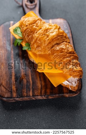 sandwich croissant with cheese fast food takeaway meal food snack on the table copy space food background rustic top view