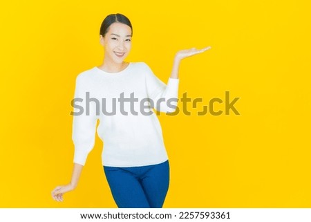 Portrait beautiful young asian woman smile with action on color background