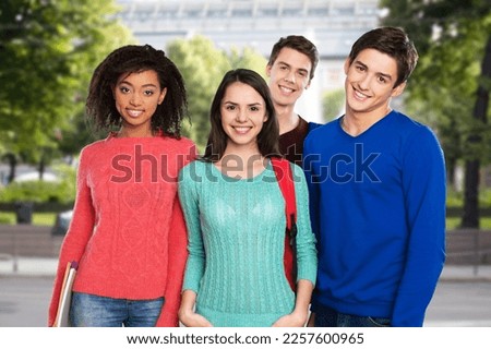 Multiracial happy student friends posing on outdoor
