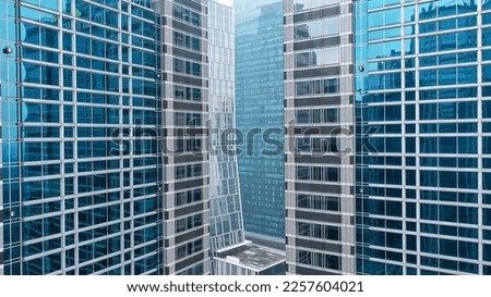 Skyscrapers reflecting in other skyscrapers with glass fasade.