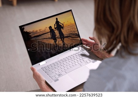 Watching TV Video On Laptop Online On Couch