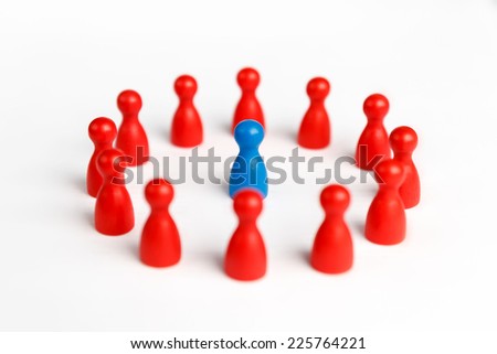 Surrounded by adversity or praised for being different concept with figurines Royalty-Free Stock Photo #225764221