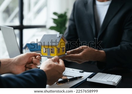 Real estate agent explaining details to his customer in the office room. Real estate, house investment concept. 