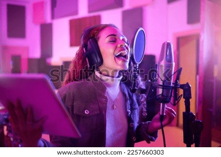 Technology, singing or woman on neon microphone, music studio lyrics or songwriting app in night recording. Singer, musician or artist on tablet in production, voice media or sound light performance