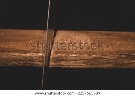 Man cutting wood with steel ax