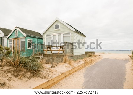 Wooden beach huts at the seaside on Hengistbury Head, Dorset, UK Royalty-Free Stock Photo #2257692717