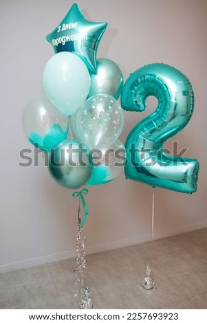 a bunch of mint-colored balloons, the inscription on the balloon "Happy Birthday", a mint-colored foil number "2"
